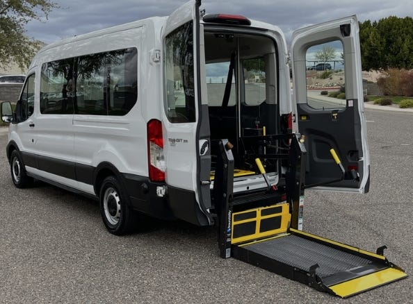 white commercial van with wheelchair ramp