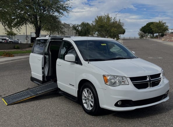 white dodge driverge wheelchair van with ramp deployed